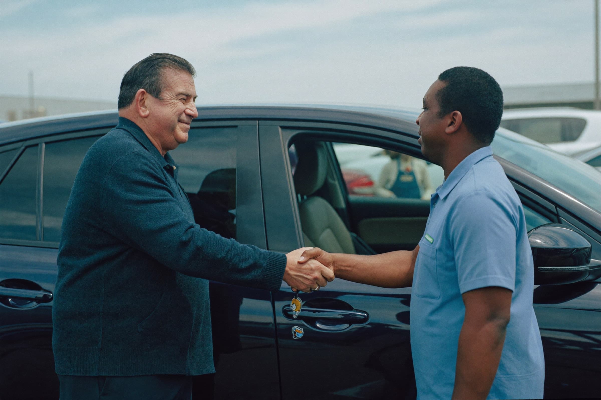 A handshake over a car sale in a dealership